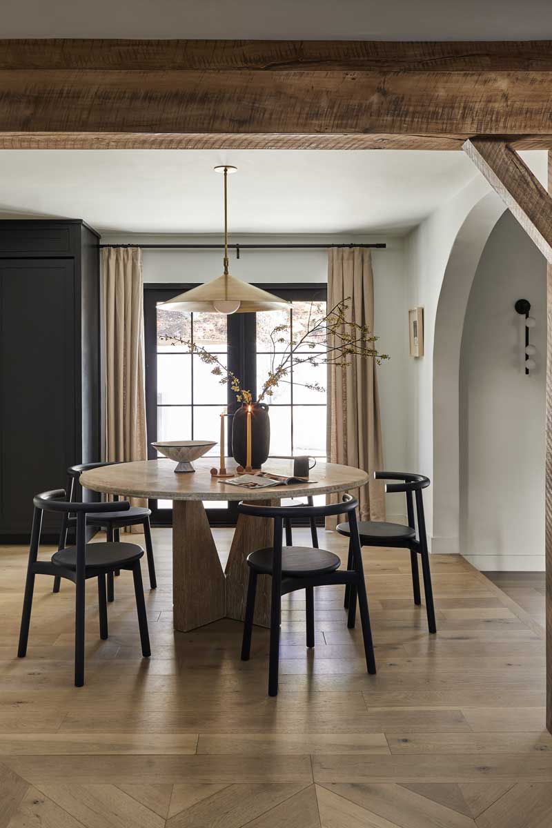 A dining table in the Bobby Berk Firm’s office space featuring a Marvin Ultimate Outswing French door G2.