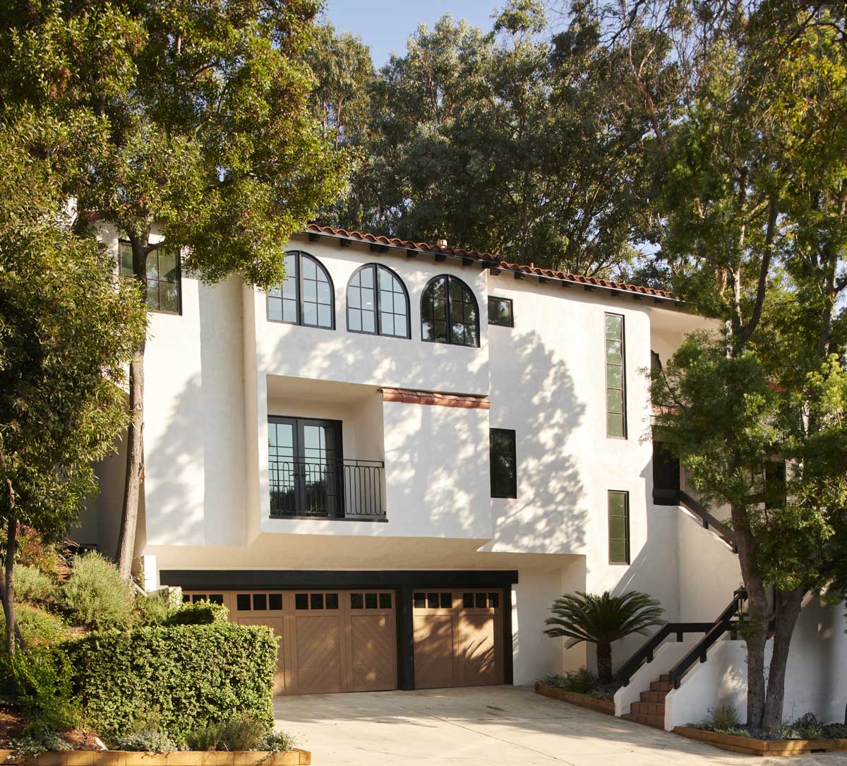 The exterior a Spanish Mediterranean home in California, featuring Marvin Ultimate Round Top windows and Marvin Ultimate windows and doors throughout.