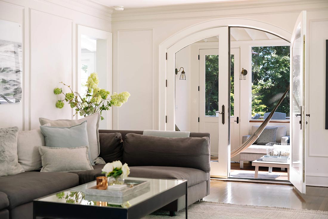 Living room with round top swinging French doors.