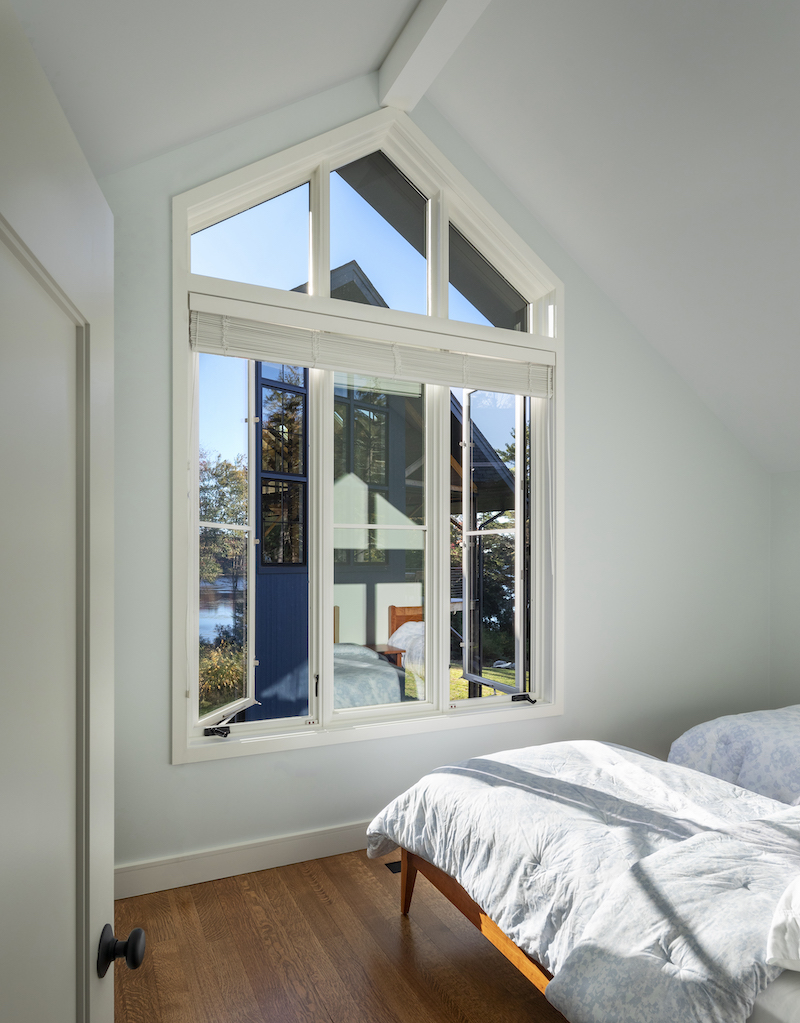 A bedroom above the three Marvin Ultimate casement windows there are three stationary windows that form a triangle which matches the angle of the ceiling.