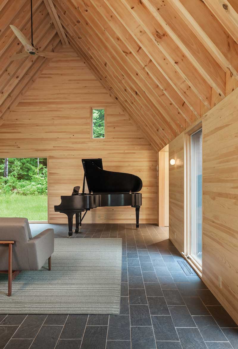 Interior photo of Marlboro Music Cottages, featuring Marvin Ultimate Casement windows and Ultimate Picture windows beside a black grand piano. 