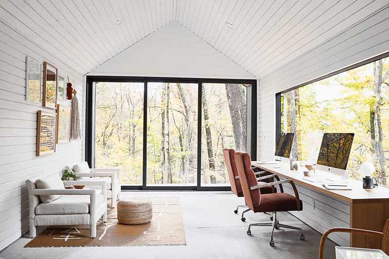 Sarah Sherman Samuel’s home office in the woods, featuring Marvin Modern windows and doors.