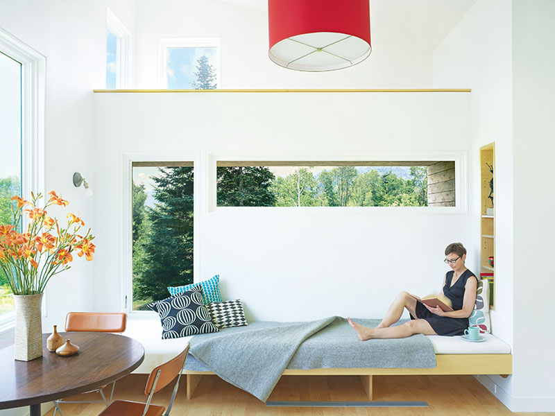 The eating and living area of a micro house in Vermont, featuring Marvin windows and doors. 