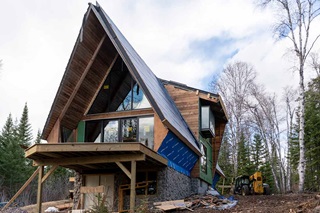A photo of The Minne Stuga, an A-frame cabin in Grand Marais, MN, during installation of Marvin windows, doors, Awaken skylights, and Skycove.
