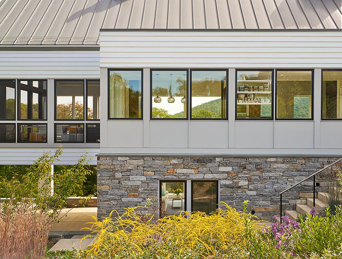 Exterior of modern farmhouse with multiple Marvin Windows and Doors