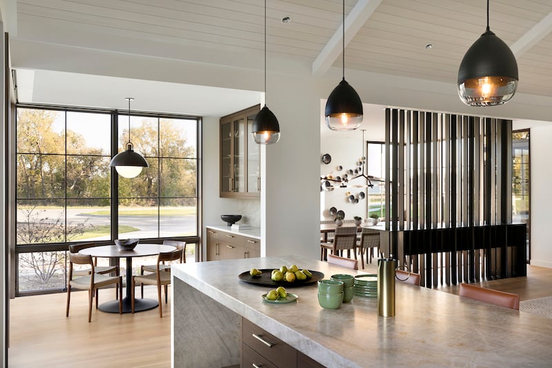 A modern kitchen and breakfast area with Marvin Ultimate windows.
