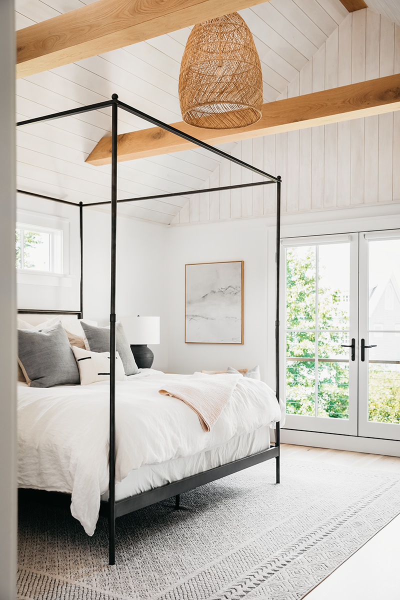 A bedroom in Liz Joy’s remodeled home, featuring a Marvin Elevate Inswing French door and Elevate direct glaze windows.