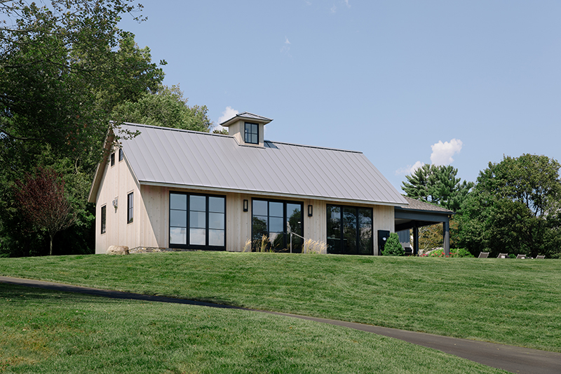 Exterior image of a modern farmhouse overlooking Shorehaven Golf Club in Norwalk, Connecticut, featuring Marvin windows and doors. 