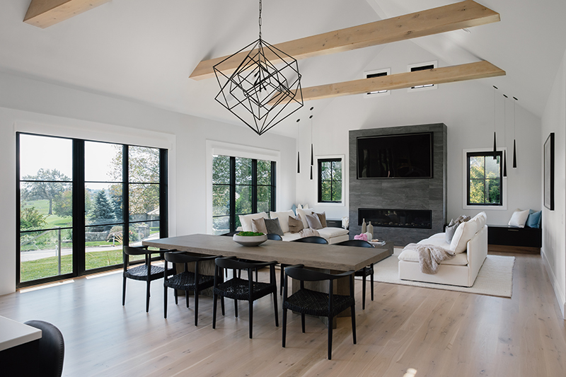 The living room of a modern farmhouse in Norwalk, Connecticut, featuring Marvin black windows and doors.