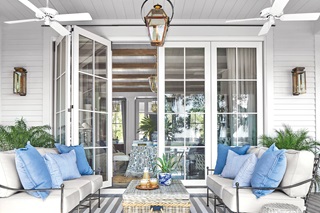 A porch featuring a Marvin Signature Ultimate Bi-Fold Door and resort style decor.
