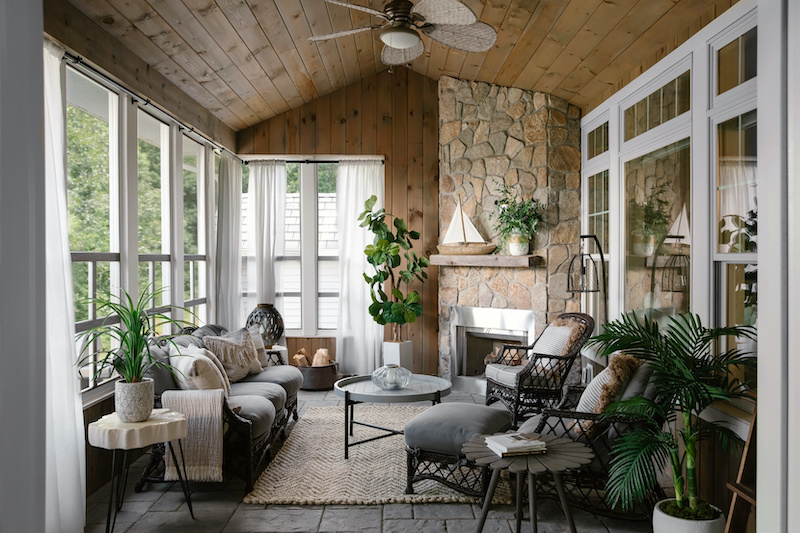 A screened porch with resort style decor and Marvin Elevate double hung and picture windows.