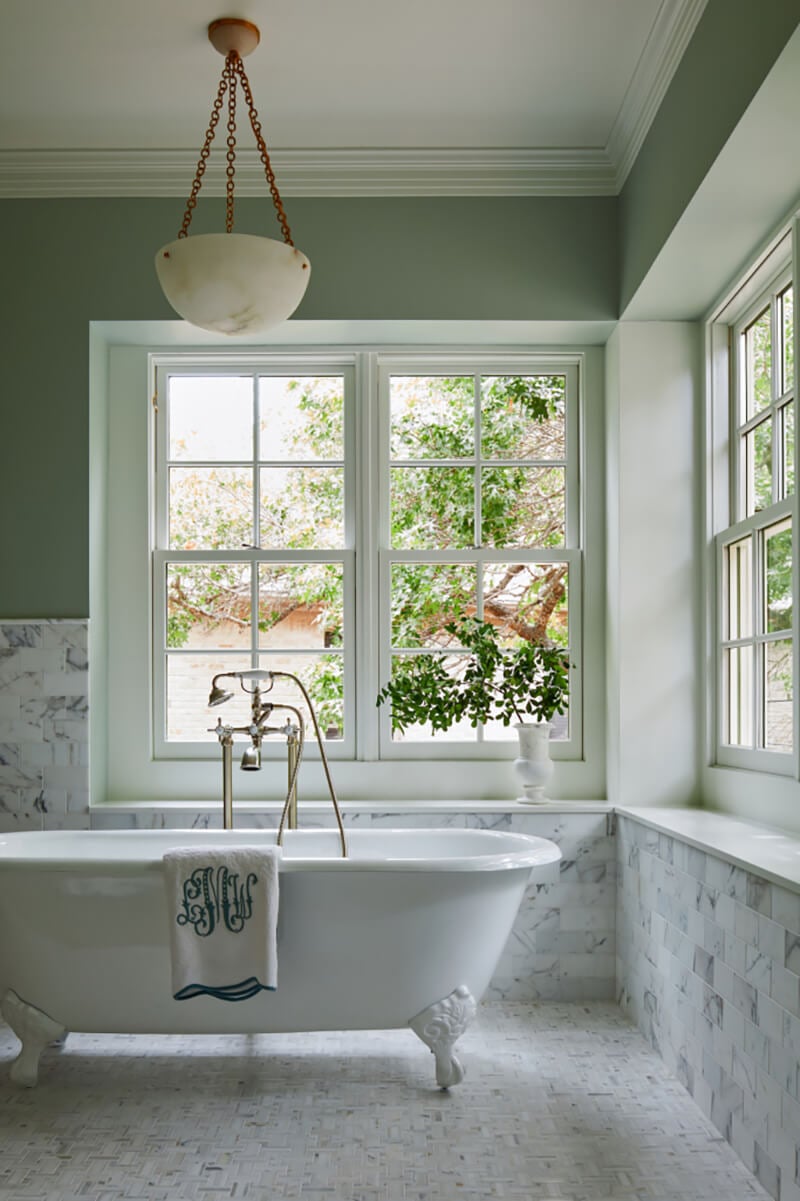 Traditional claw foot tub in front of Marvin Windows