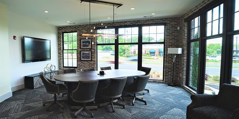 Renovated conference room with floor-to-ceiling Marvin casement windows.