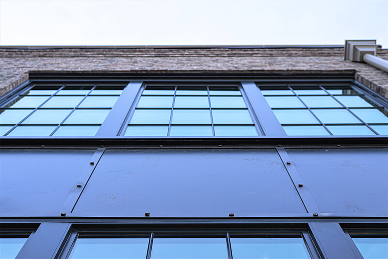 Exterior of a commercial building with industrial-style steel look windows.