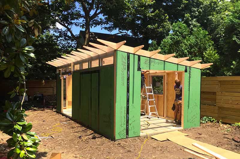 A Studio Shed being built in a backyard.