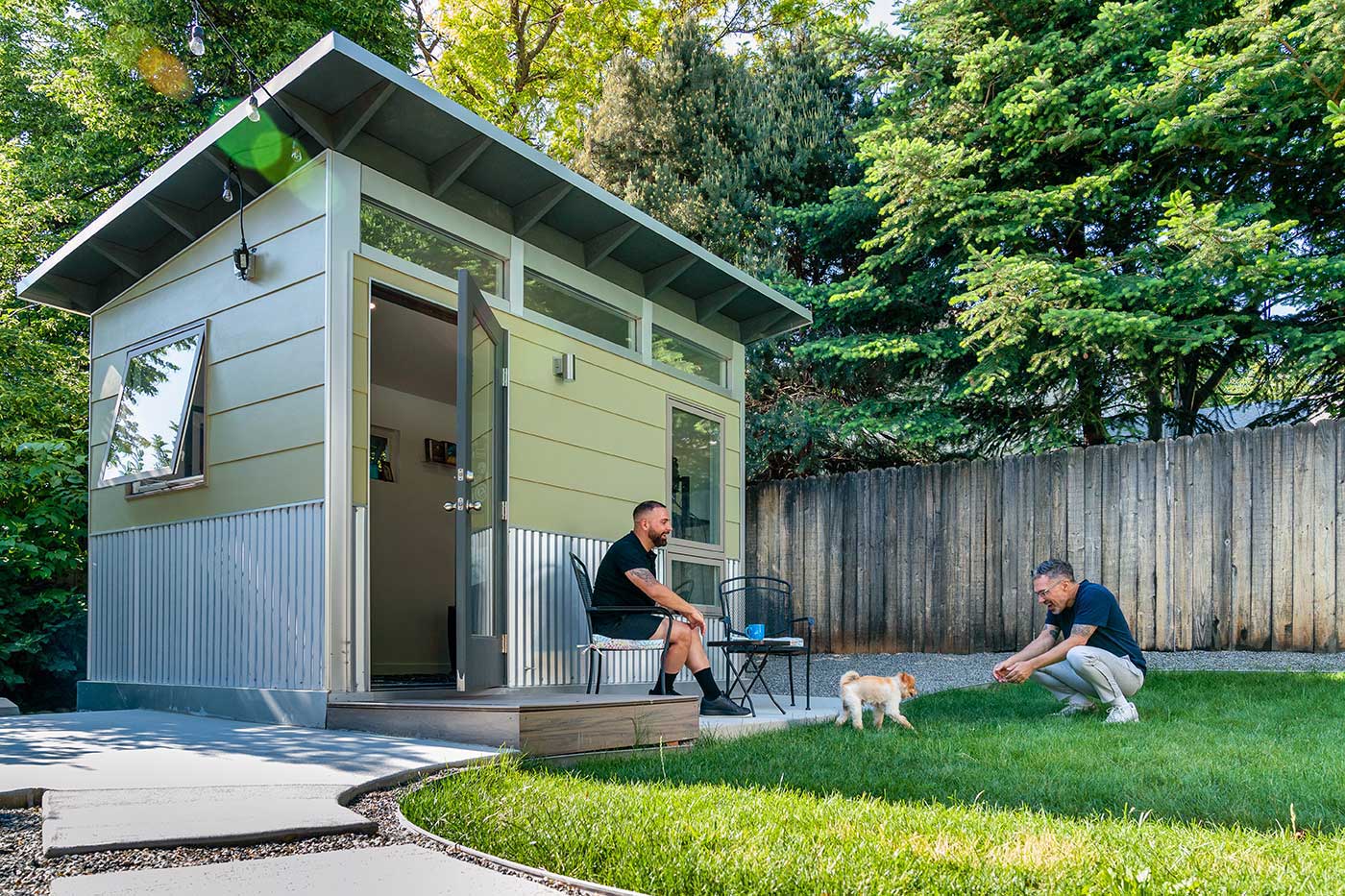 A green Studio Shed Accessory Dwelling Unit (ADU) featuring Marvin Essential windows.