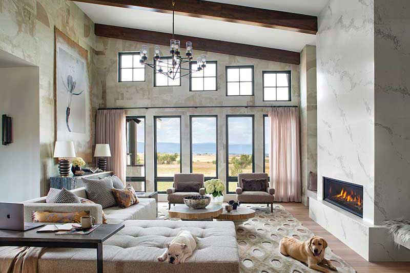 A neutral country great room with mountain views using Marvin Ultimate, Awning, and Casement windows.