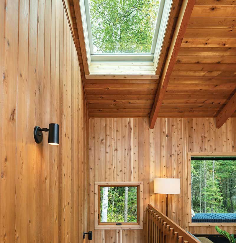 An A-frame cabin in Northern Minnesota, featuring cedar-clad walls, a Marvin Awaken Skylight, Marvin Skycove and an Ultimate Awning window.