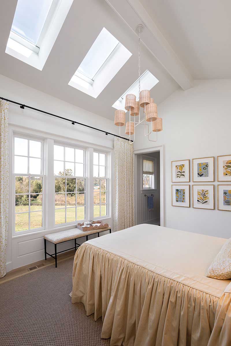 A bedroom in the Southern Living Idea House featuring three Marvin Awaken Skylights and Ultimate Double Hung G2 windows.