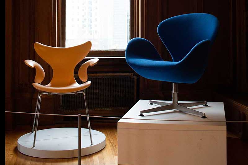 Two Scandinavian-style chairs, a brown one on the left and a blue swivel chair on the right, at the American Swedish Institute in Minneapolis, MN.