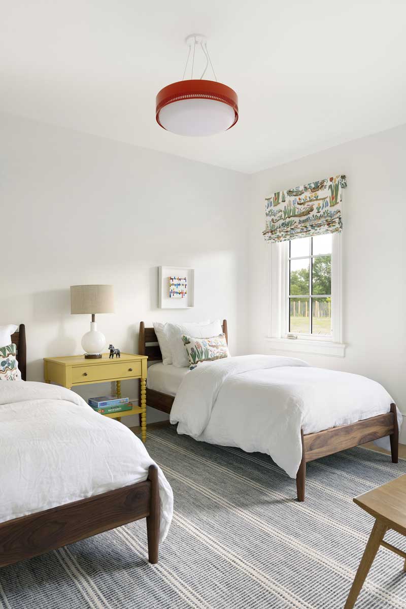 A white bedroom with two twin beds