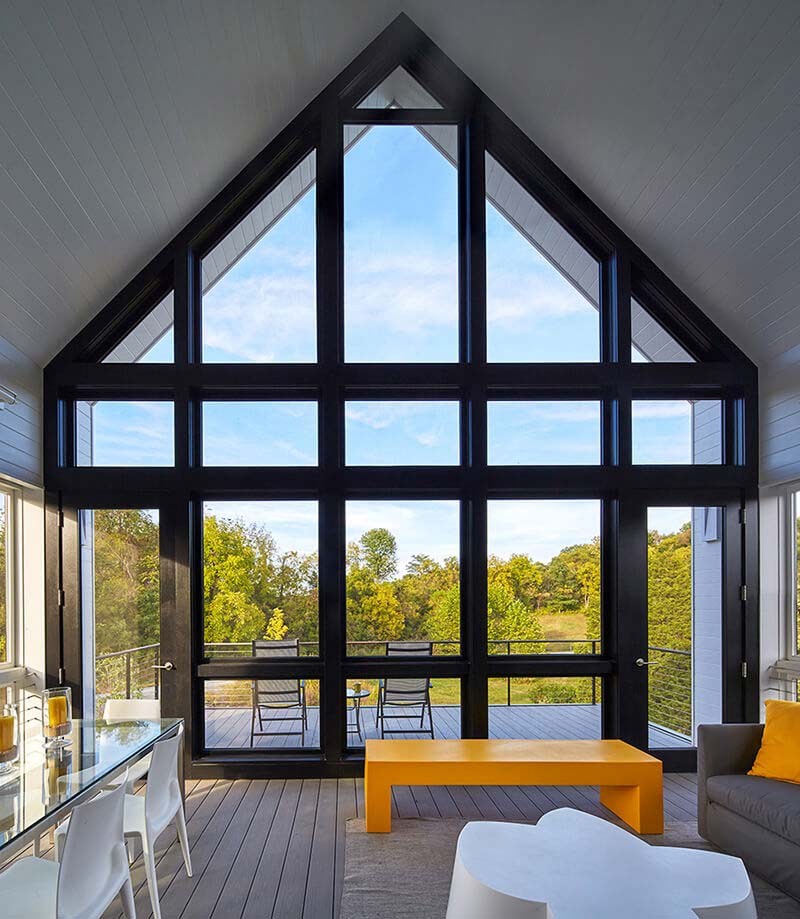 Large A Frame house interior with floor to ceiling windows
