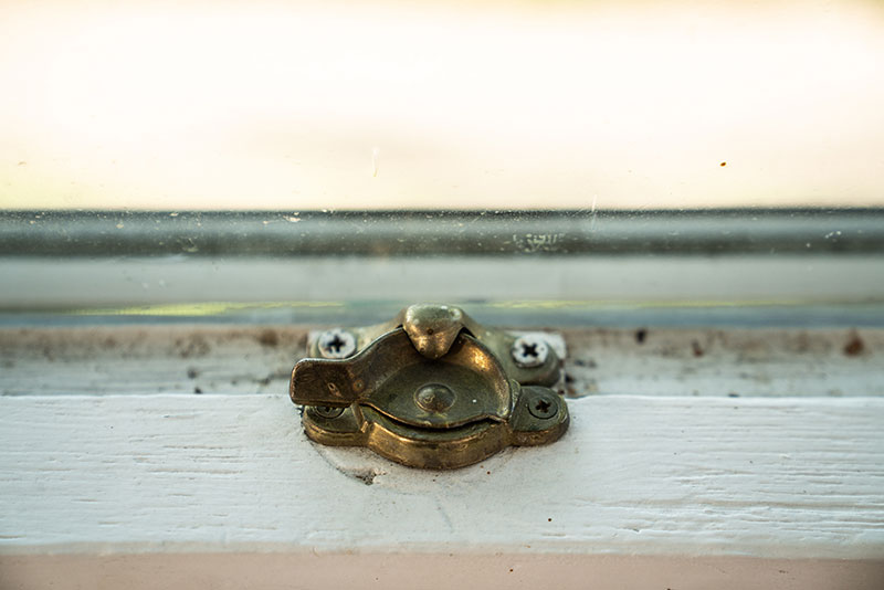 An old lock on a double hung window.