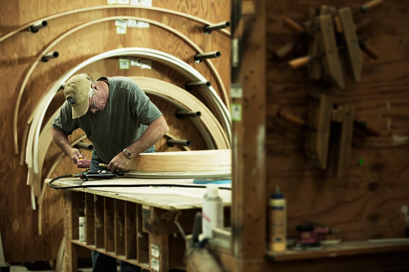 A manufacturing employee crafting a Marvin historic window.
