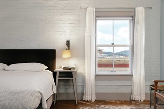 Marvin Ultimate Double Hung window in a bedroom with views of downtown and hills beyond. 
