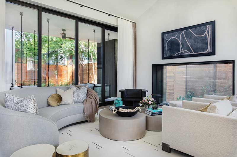 A contemporary living room in Stay Bungalow in Austin, Texas, featuring a Marvin Modern Multi-Slide door.