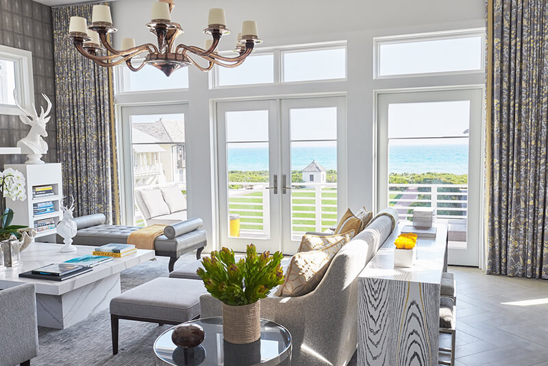 Living room of beach home with multiple Marvin Windows and Doors