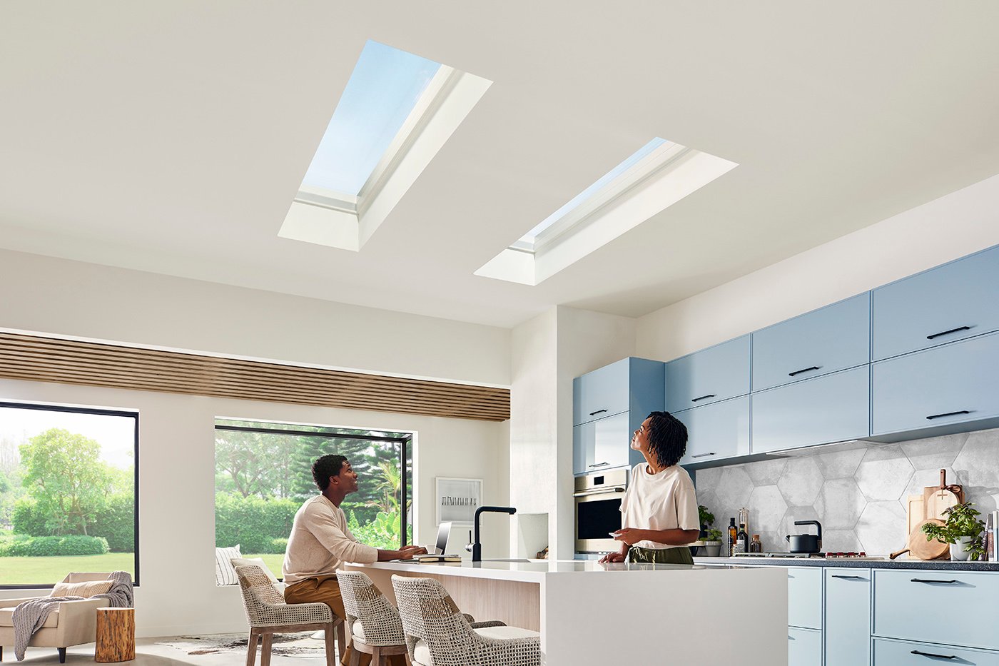 A man and woman in a modern kitchen featuring Marvin Awaken Skylights and Marvin Skycove.