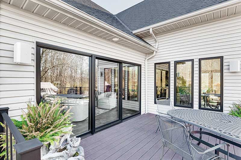 Looking at a home from the deck with a Marvin Bi-Fold door and Marvin casement windows.