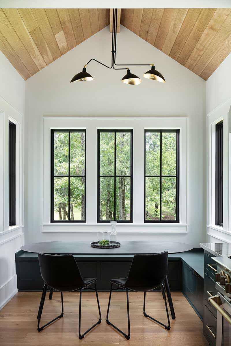 A modern seating area featuring black Marvin Elevate collection windows.
