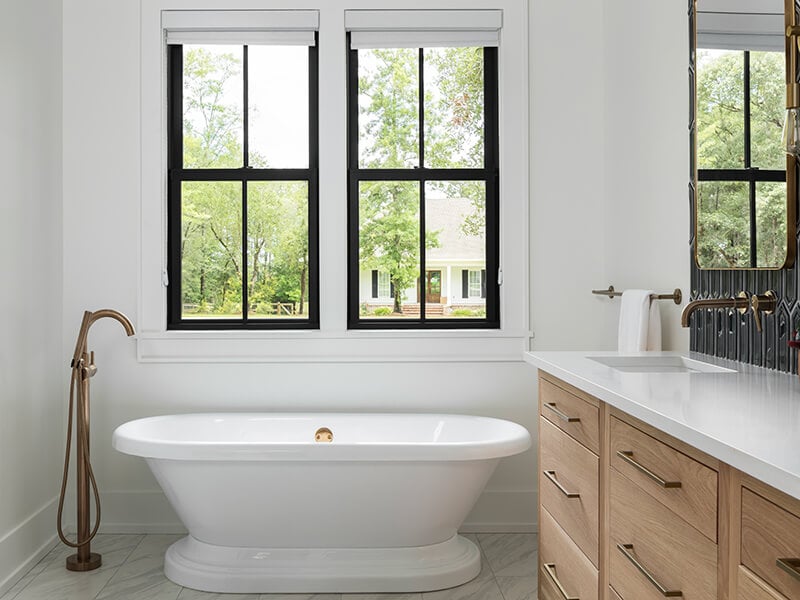 A bathroom featuring black Marvin Elevate collection windows.