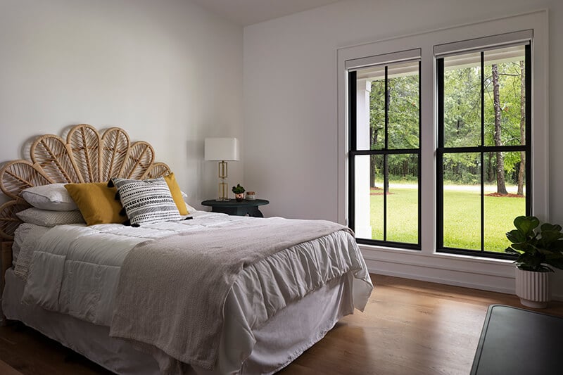 A bedroom featuring black Marvin Elevate collection windows.