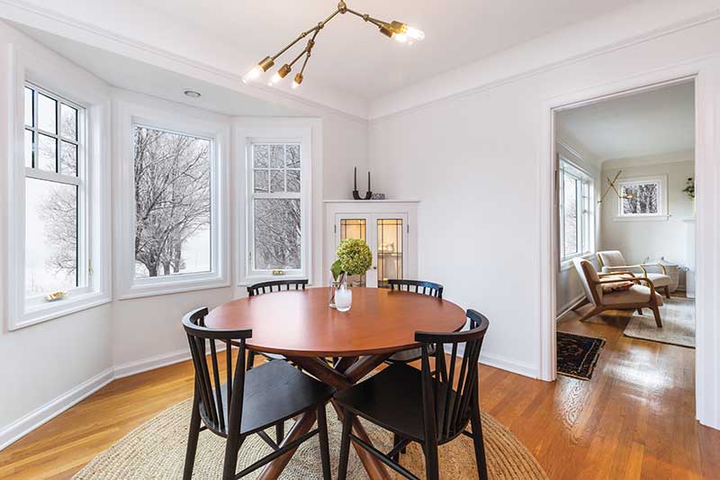 A bright dining room in winter with Infinity by Marvin picture windows.
