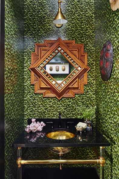 Unique bathroom with wallpaper and gold colored sink