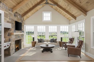 A living room with a fireplace and a Marvin Ultimate Double hung windows