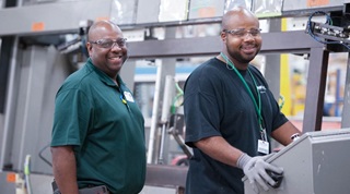 Two Marvin employees working at their workstation in the warehouse