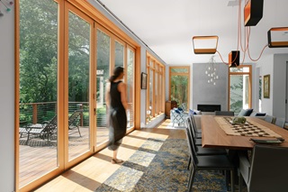 Woman in living area of home with multiple Marvin Windows and Doors
