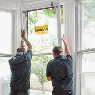 Two men installing a Marvin window