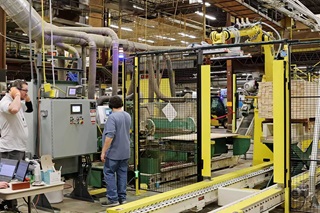 Two workers operating machine at Marvin Windows and Doors Warroad facility
