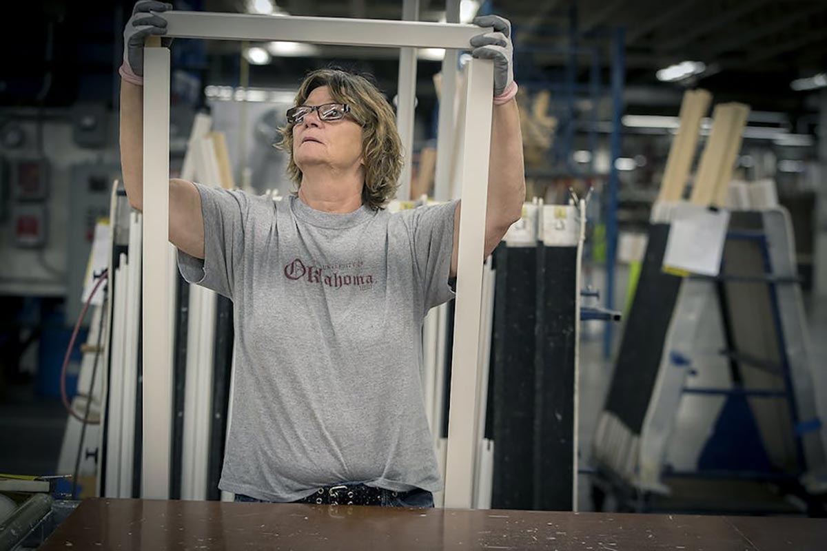 Woman in warehouse putting together Marvin Window frame