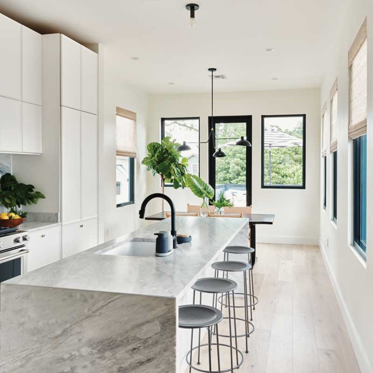 Kitchen with white marble countertop and casement windows