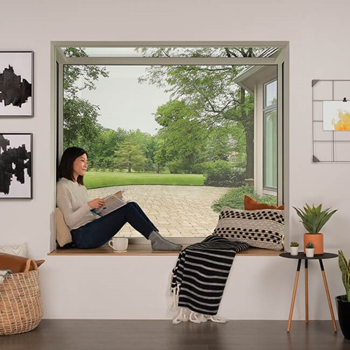 Interior of home with Woman sitting in Marvin Skycove window box
