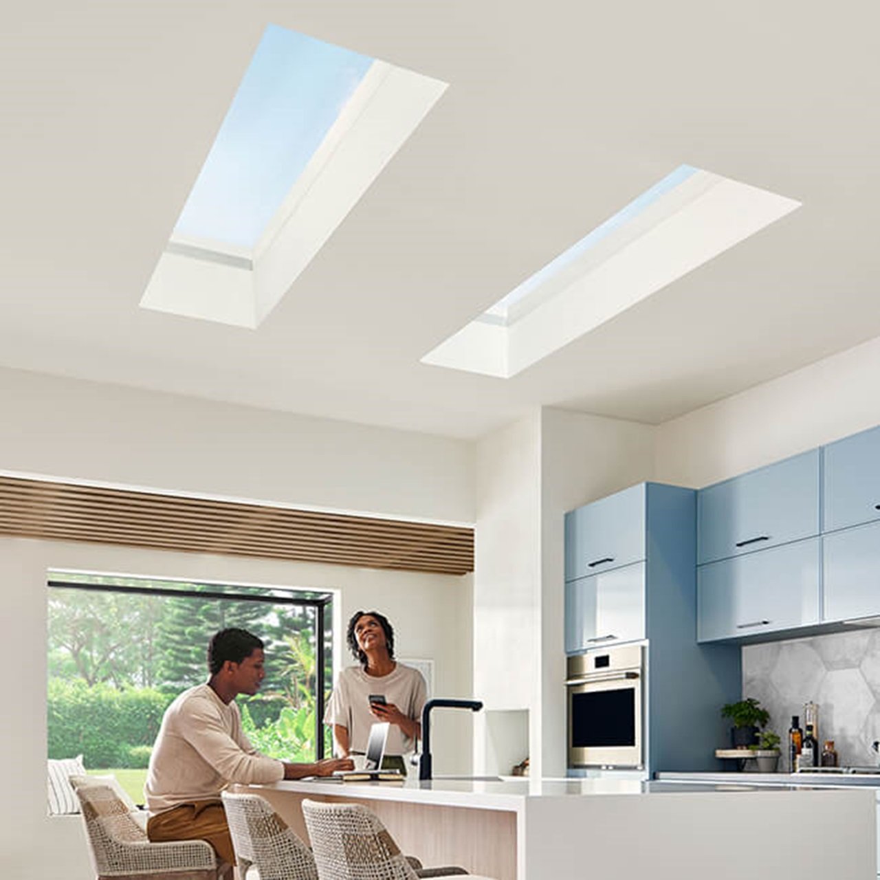 Interior of home with two people sitting in Kitchen with Marvin Skycove window box and Marvin Awaken Skylights