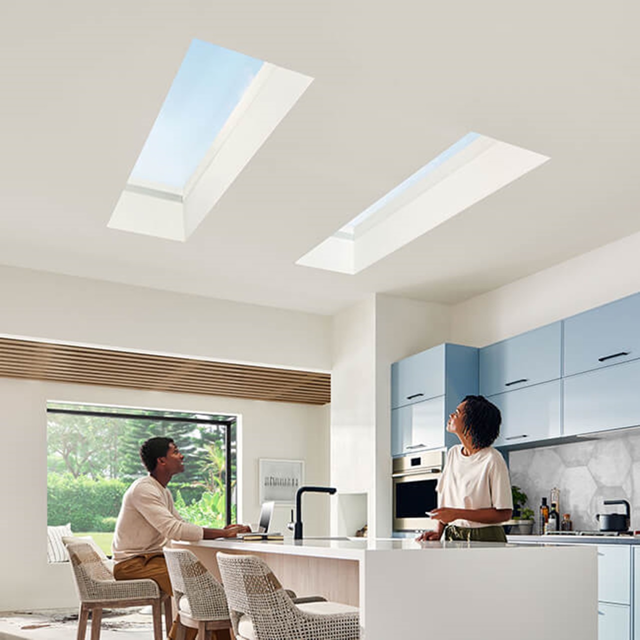 Interior of home with two people in Kitchen with Marvin Skycove window box and Marvin Awaken Skylights