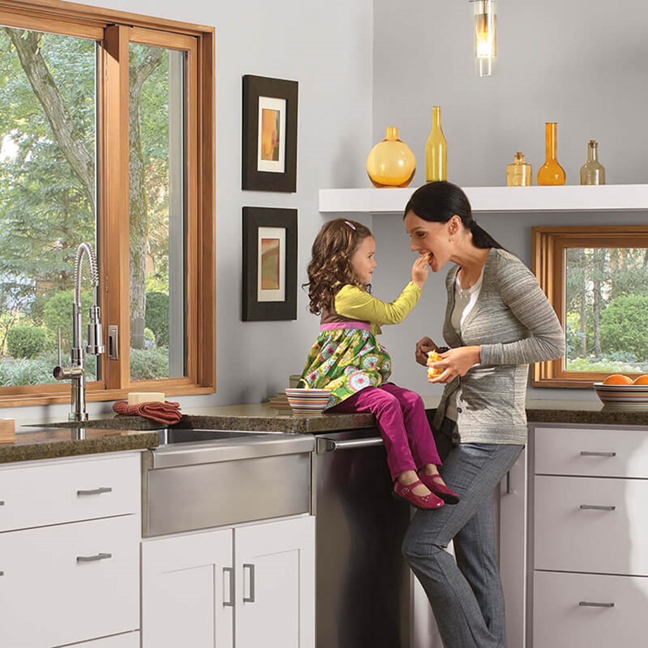 Mother And Daughter In Kitchen With Signature Ultimate Glider Window