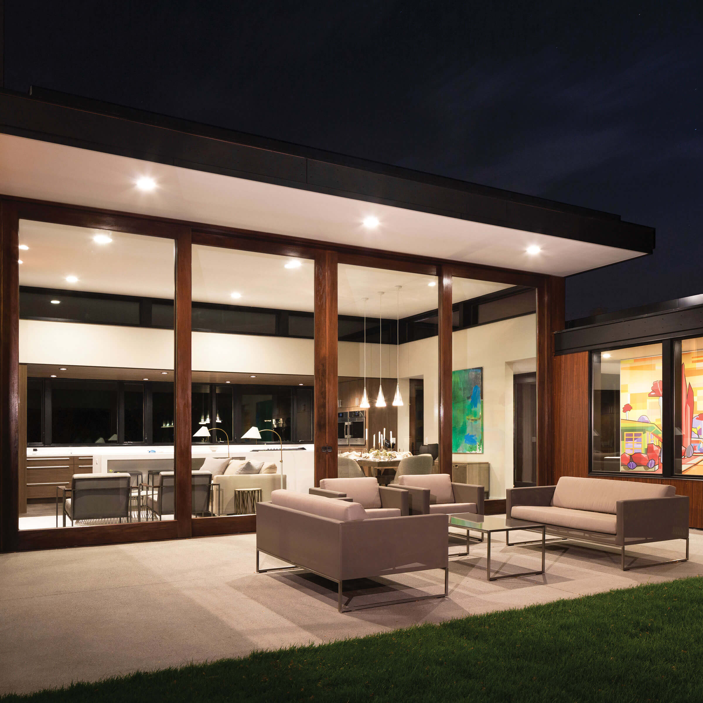 Exterior View At Night Of Patio And House With Signature Ultimate Lift And Slide Door 